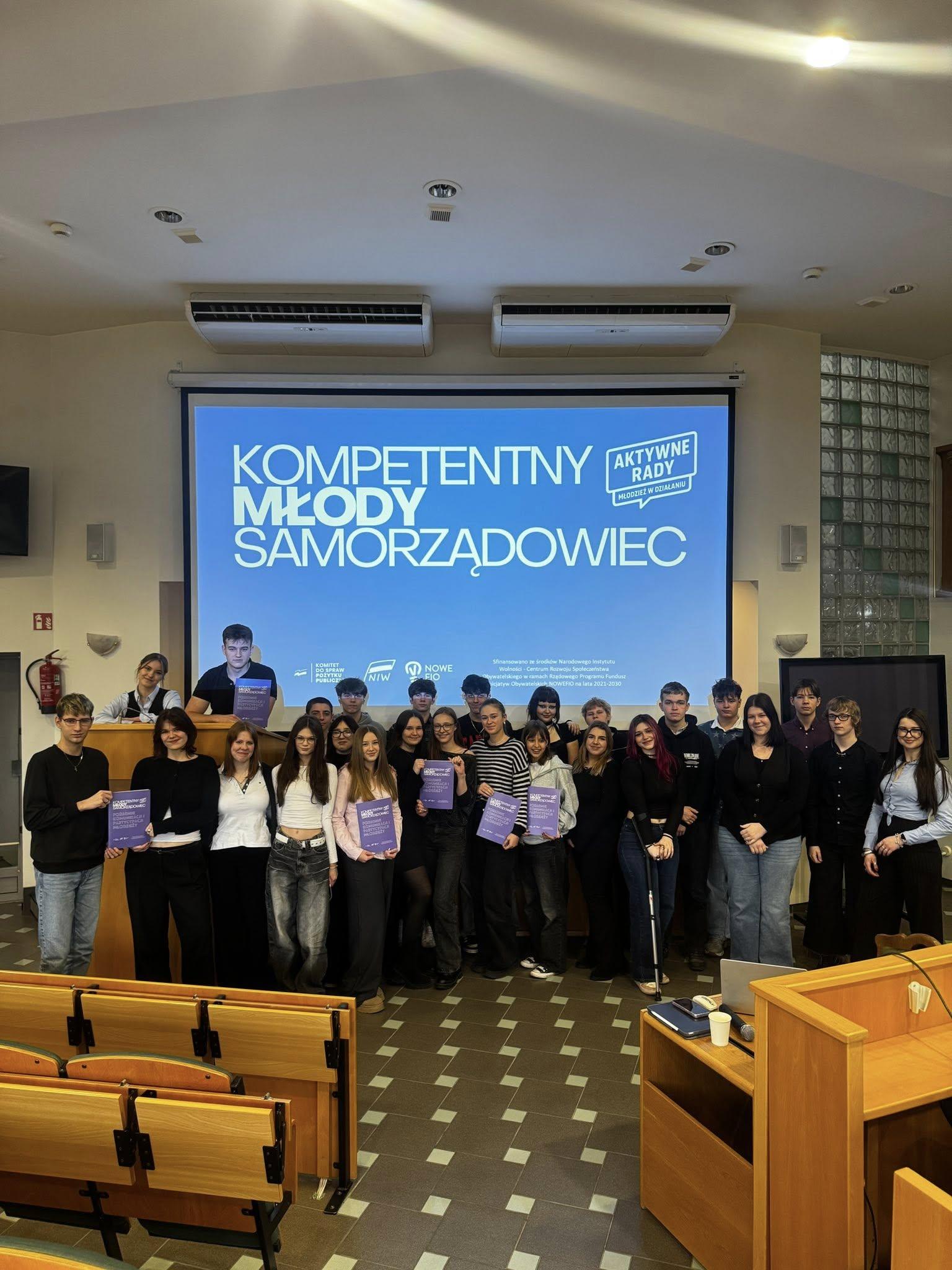 Group photo of young people in a council chamber during activities of the project “Active Councils – Youth in Action!”