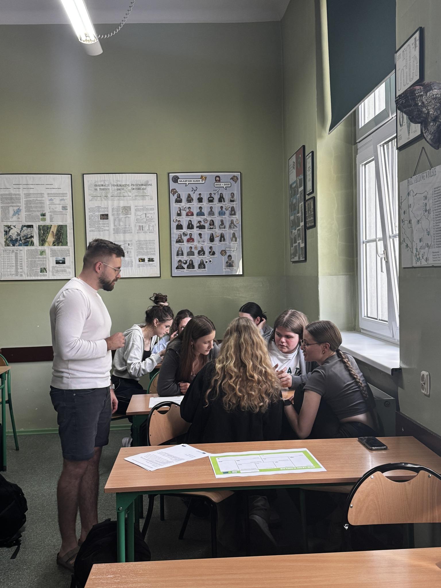 The instructor presents material during a class session as part of the project.