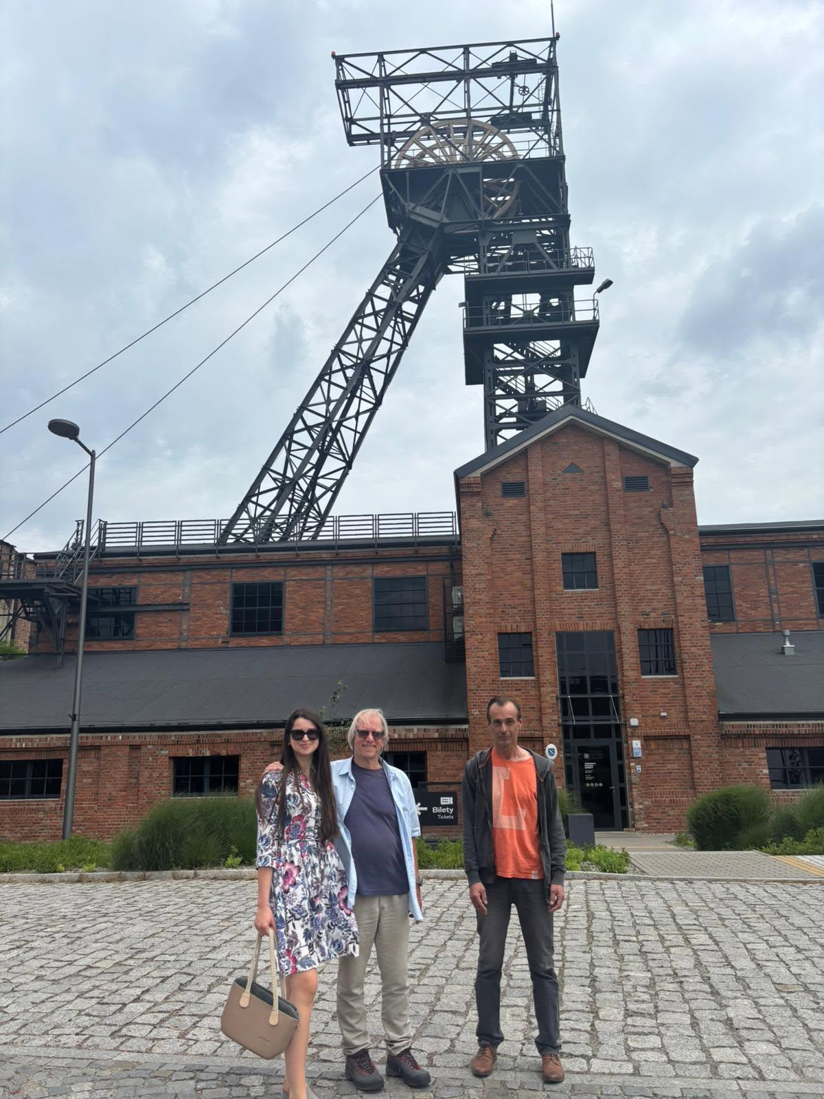 Three study-visit participants in front of the shaft at the historic Ignacy Mine in Rybnik
