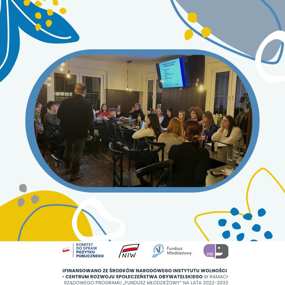 Project graphic showing a group of female participants sitting at a table during a youth meeting.