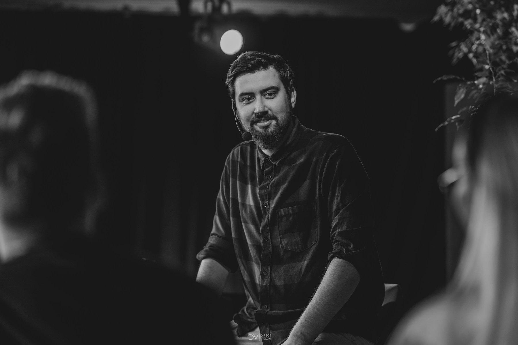 Piotr Tłustochowicz listening to event participants