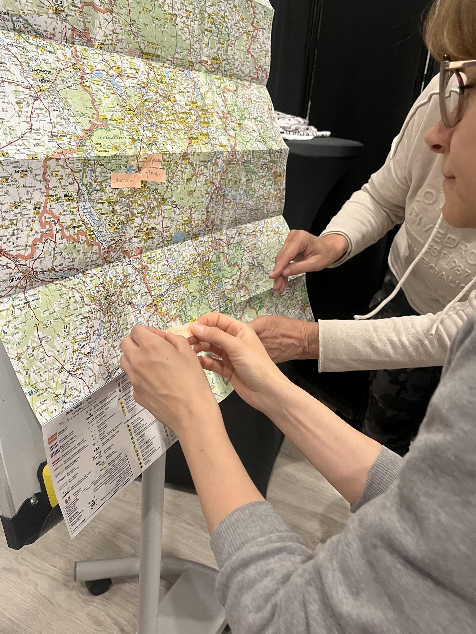 Participants at a map mark locations during workshops related to the region’s traces.