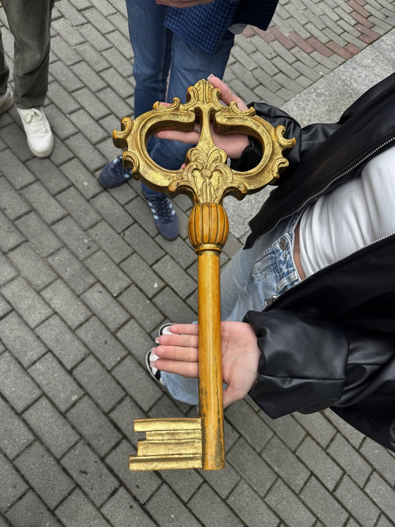 An ornate golden key symbolically presented to young people during Rybenalia