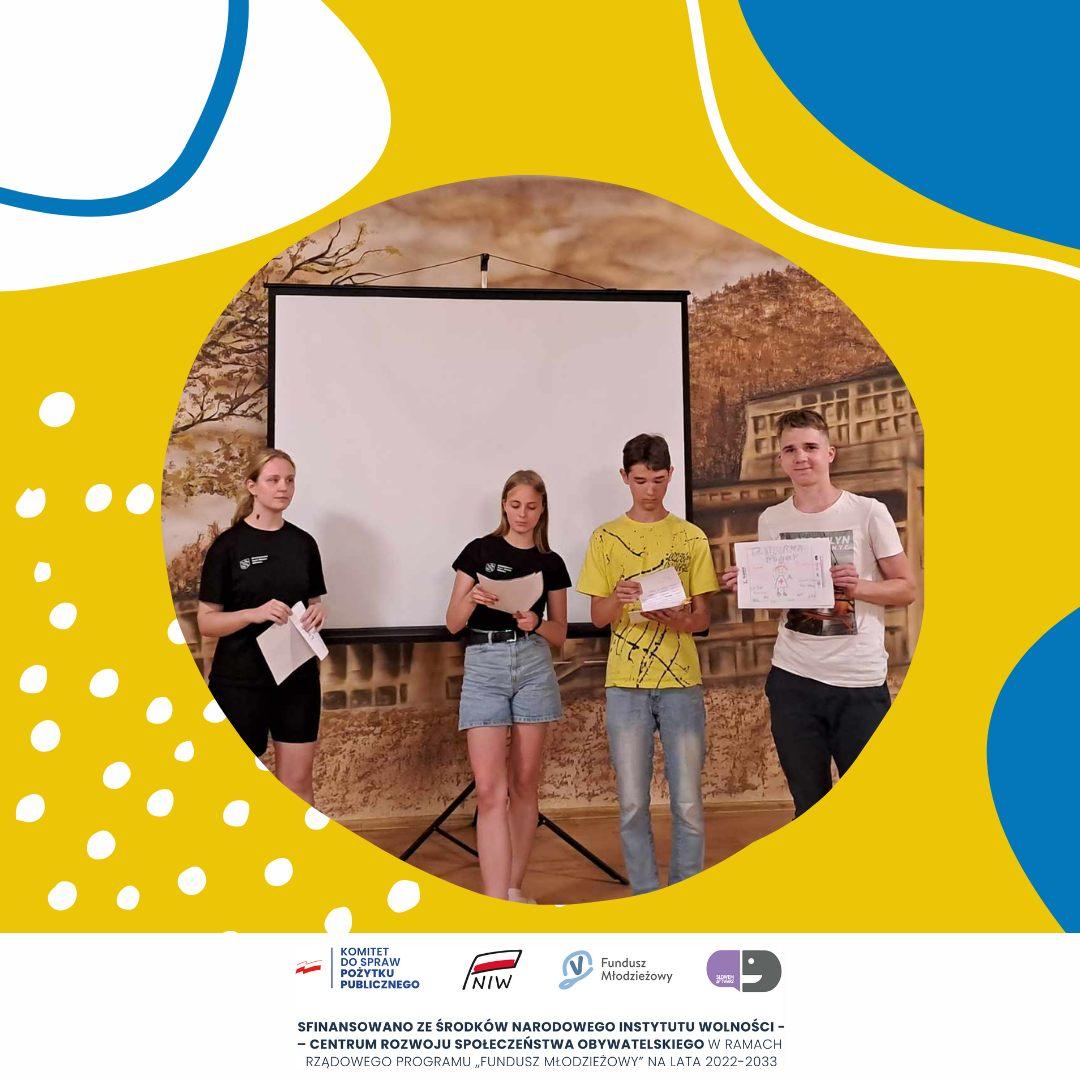 A facilitator meeting with young people during workshops in a training room.